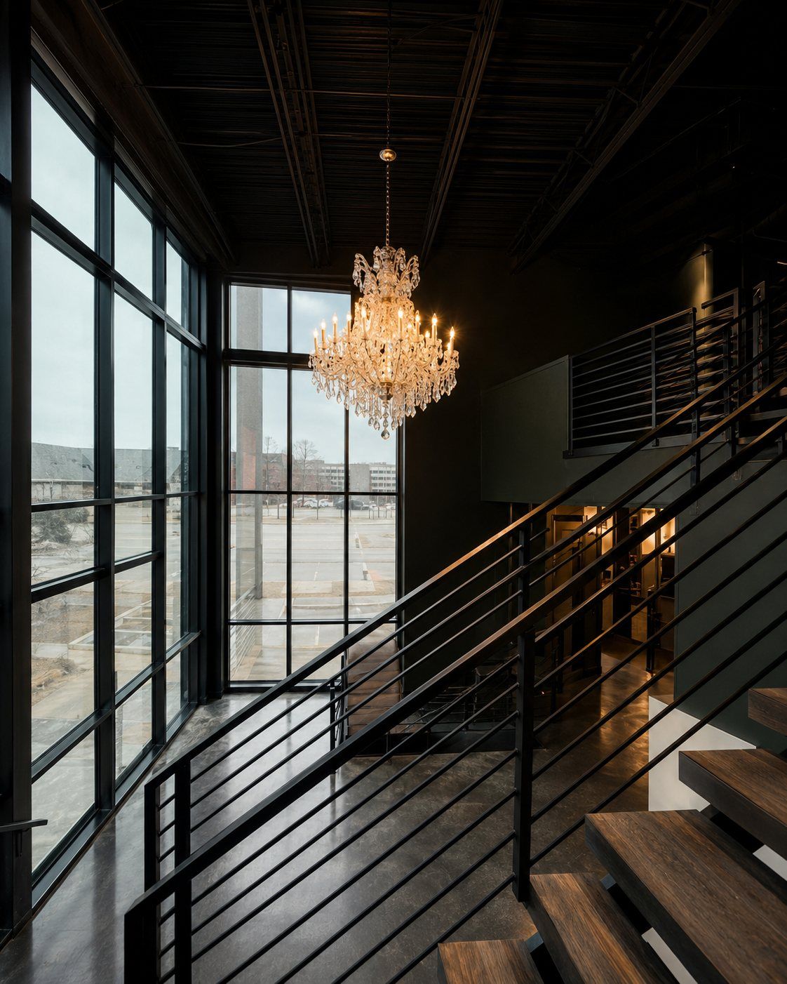 The Von Rae stairwell with crystal chandelier and floor-to-ceiling windows