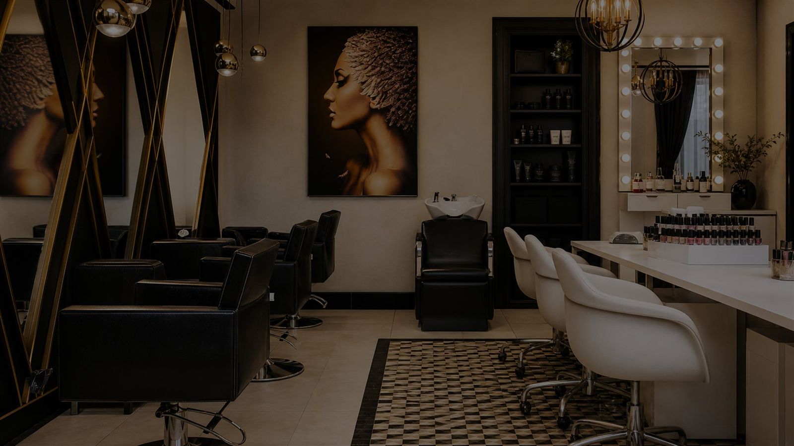 A Von Rae styling floor with black leather chairs, gold accents, and a lit vanity mirror