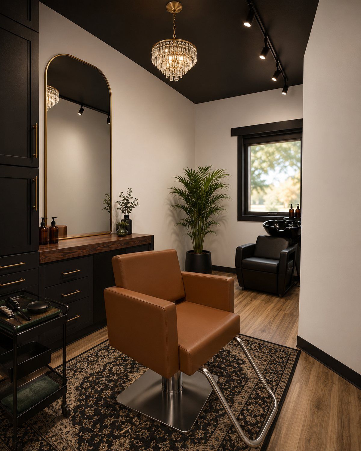 A Von Rae single suite with cognac styling chair and gold arch mirror